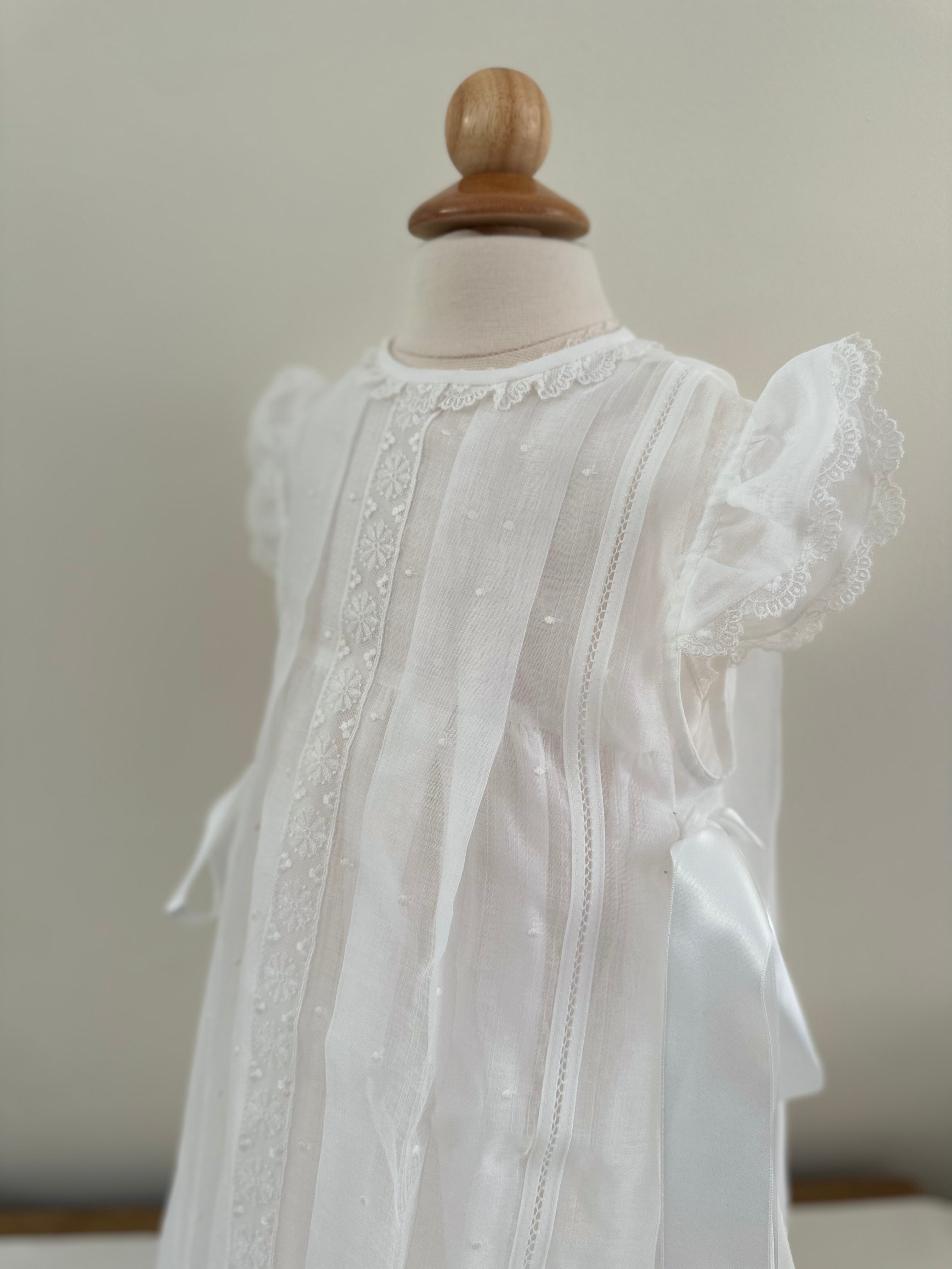 special occasion dress in white with bows to the side by Creaciones Charo. Made in Spain.