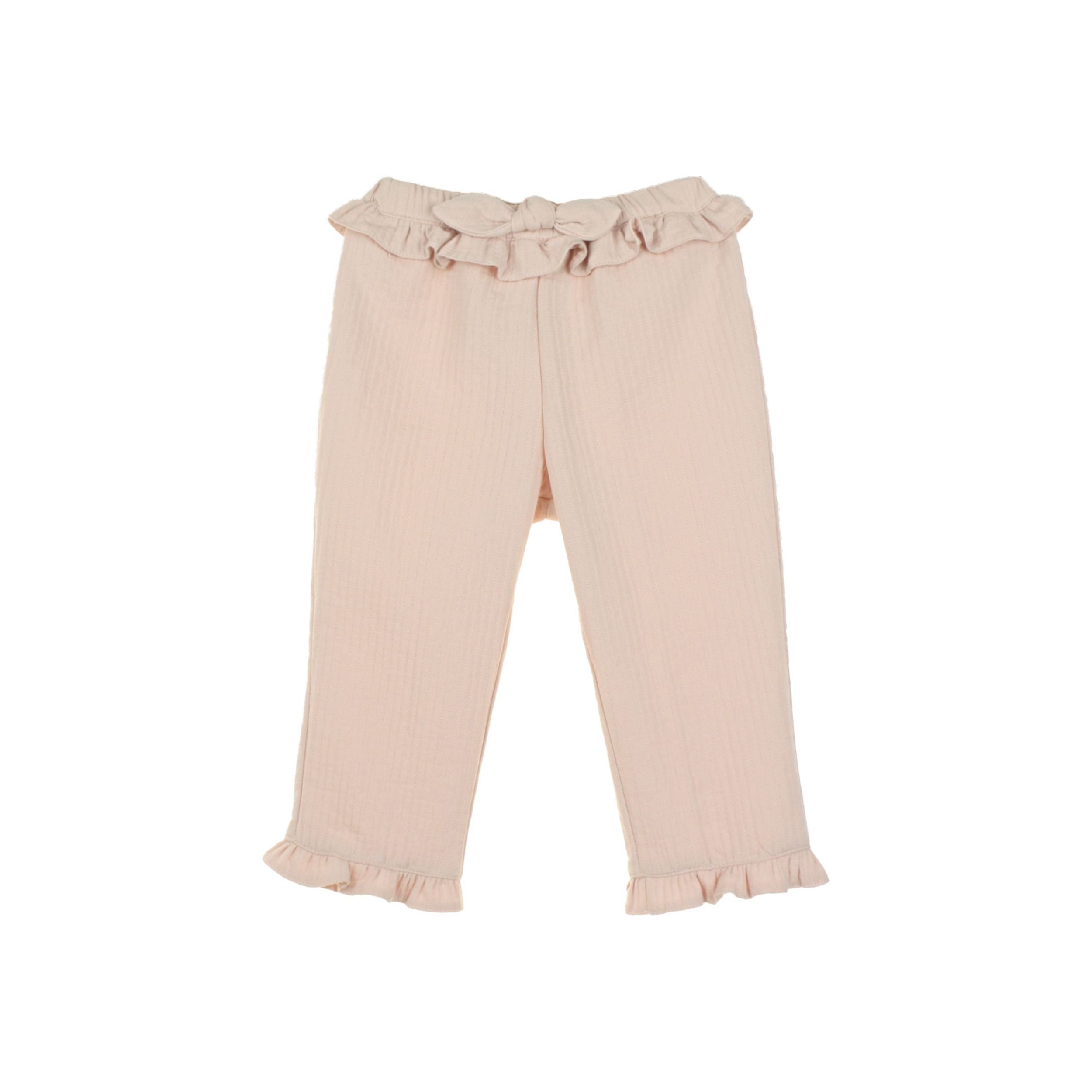 Pink pants with ruffled details on a white background