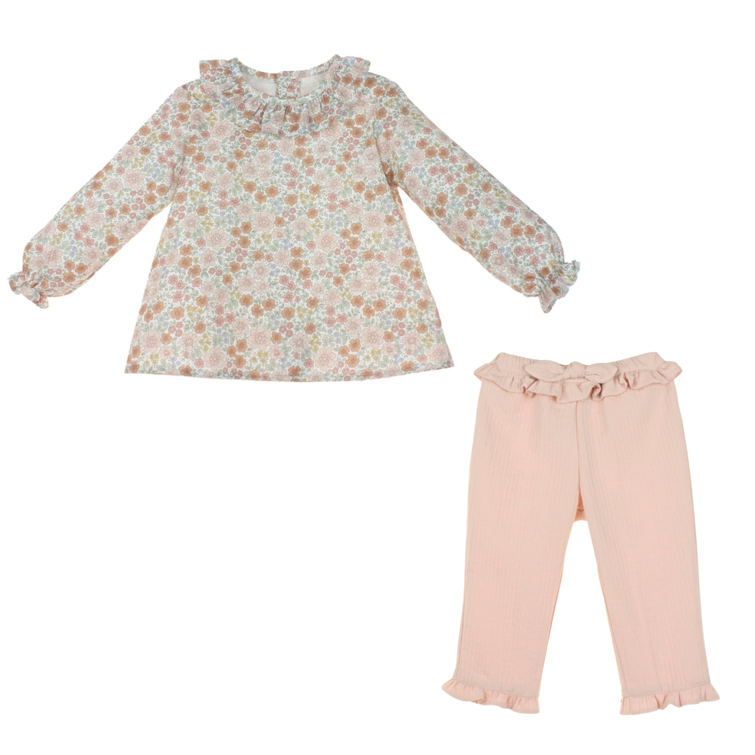 Floral blouse and pink pants set on a white background